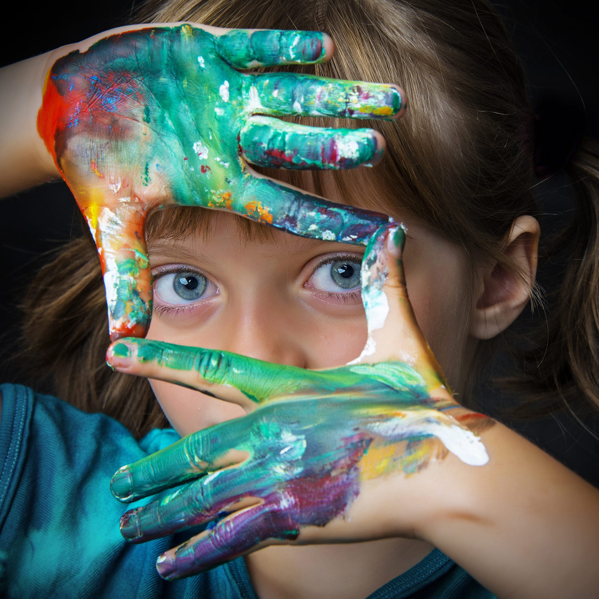 little girl with paint in her hand