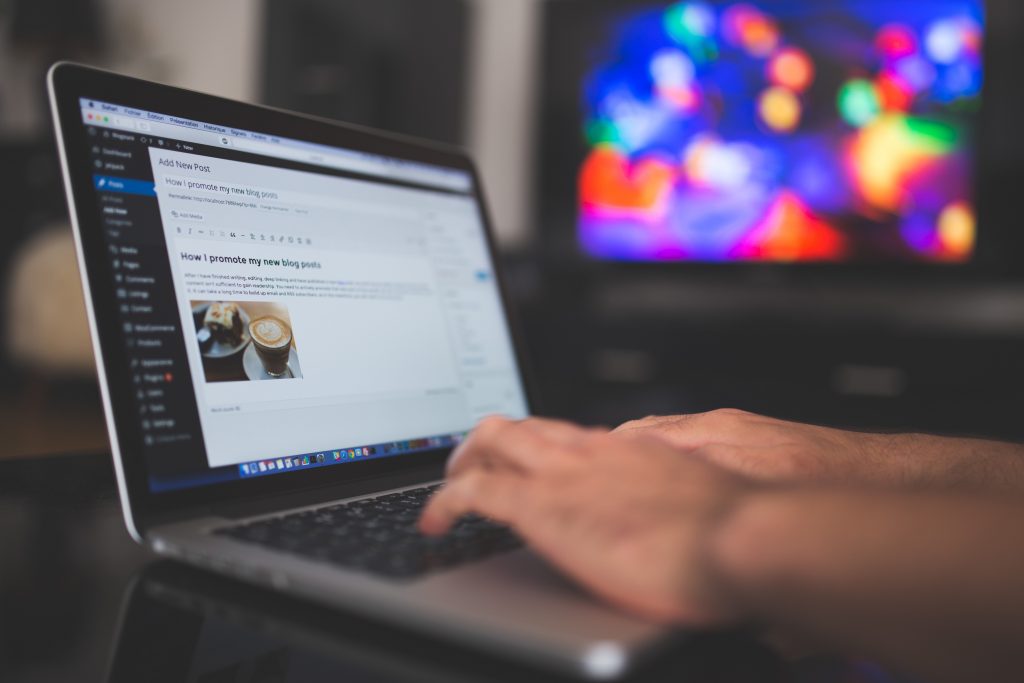 a person typing on his laptop